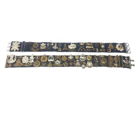 Collection of sixty-five Glengarry and cap badges, shoulder titles, collar dogs, buttons etc mounted on two military belts in