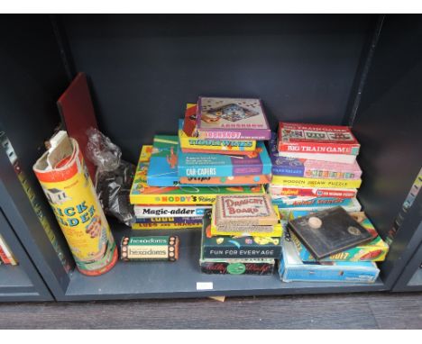 A shelf of mixed vintage games and jigsaws inc Moonshot, Spin Quiz etc