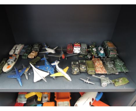 A shelf of playworn diecasts inc Corgi and Dinky military, aircraft and UFO etc