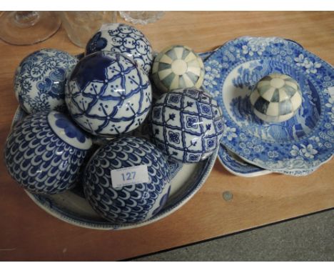 A blue and white bowl containing decorative carpet bowls and a selection of blue and white plates including Masons