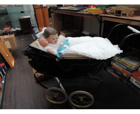 A vintage Restmor dolls pram and a pedigree composition and jointed doll along with a modern doll