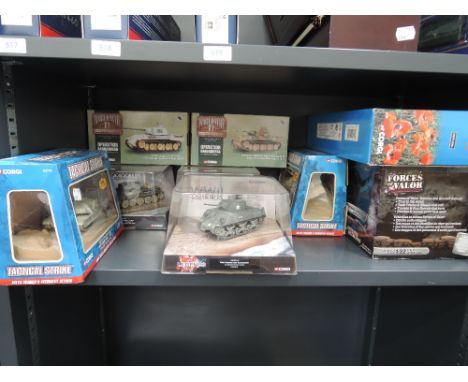 A shelf of Corgi military diecasts, in window display boxes and cases