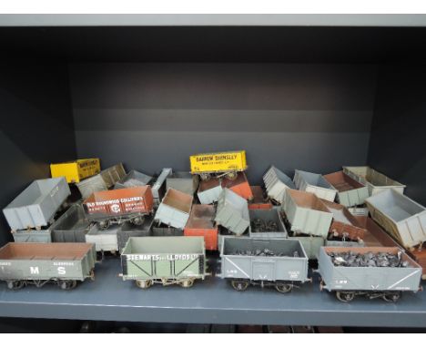 A shelf of 0 gauge scratched built open wagon inc Barrow Barnsley, Old Roundwood Collieries, Stewart and Lloyd ltd etc