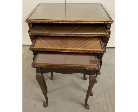 A vintage dark wood nest of 4 tables with glass inserts (1 missing) and carved detail to corners and cabriole legs. 