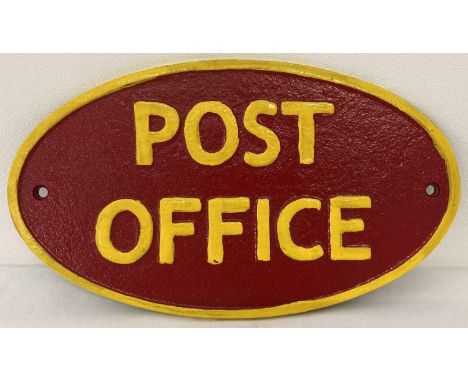 A painted cast iron oval shaped Post Office wall plaque.  In red and yellow and with fixing holes.  Approx. 14cm x 25cm. 