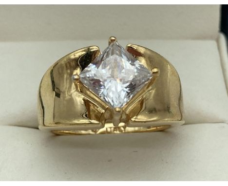 A modern design silver gilt dress ring set with a central square cut diamonique cubic zirconia stone by Veronese. Ring size M