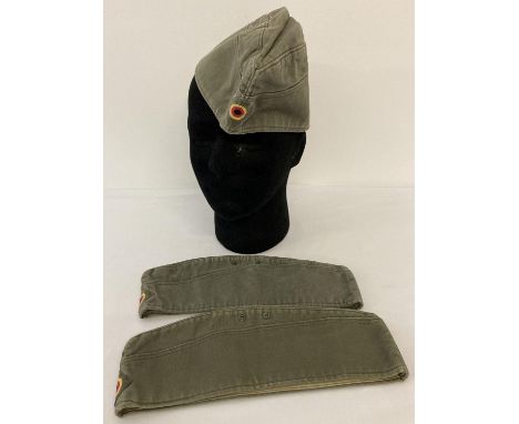 3 German Army issue side caps, green canvas with embroidered badges to fronts. 