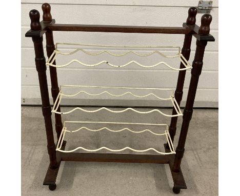 A vintage wooden framed wine bottle rack with 3 coated metal shelves. Storage for 15 bottles. 
