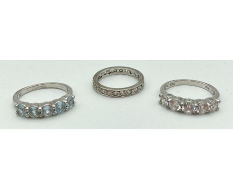 3 silver stone set dress rings. A full eternity ring set with DQCZ stones, a half eternity ring set with 5 round cut pale blu