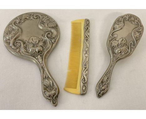 A vintage heavy silver plated 3 piece brush and mirror vanity set with decorative Art Nouveau style design handles and backs.