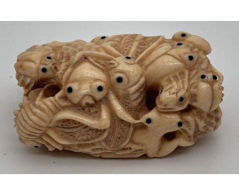 A highly carved Chinese netsuke robe toggle, in the form of a cluster of insects. Signature mark to reverse. Approx. 5cm tall