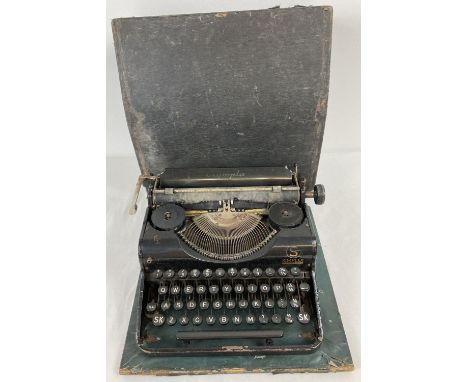 A vintage Olympia Simplex typewriter with original case. 