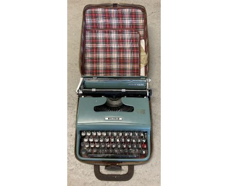 A vintage Olivetti Lettera 22 typewriter complete with original plastic cover and tartan lined carry case. 