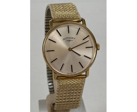 A men's slimline gold tone cased wristwatch by Rotary with expanding bracelet strap. White face with black hour markers and h
