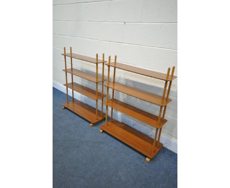 A PAIR OF MID CENTURY TEAK AND BEECH OPEN ROOM DIVIDING BOOKCASES, made up of four shelves joined by cylindrical supports, wi