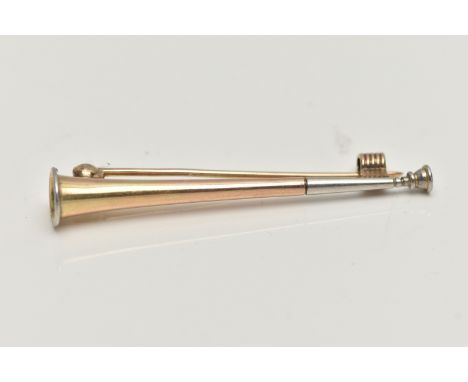 A YELLOW METAL HUNTING BROOCH, in the form of a horn with white metal mount, stamped 9ct, fitted with a brooch pin and textur