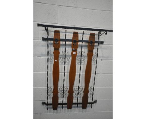 A WROUGHT IRON WALL HANGING COAT RACK, with detachable shoe shelf to top, and three wooden slats, width 85cm x depth 29cm x h