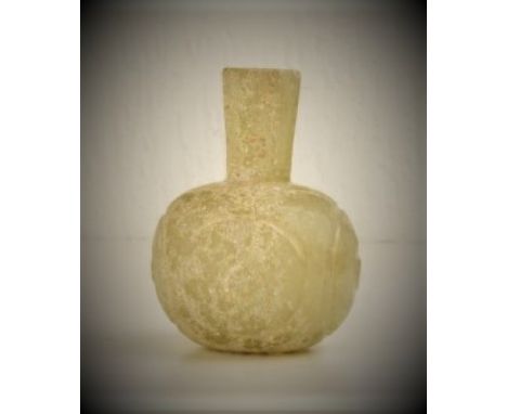 This glass bottle is from 400 to 500 AH (900 to 1000 AD). The bottle has an apple-shaped lower body, elegantly crafted upon a