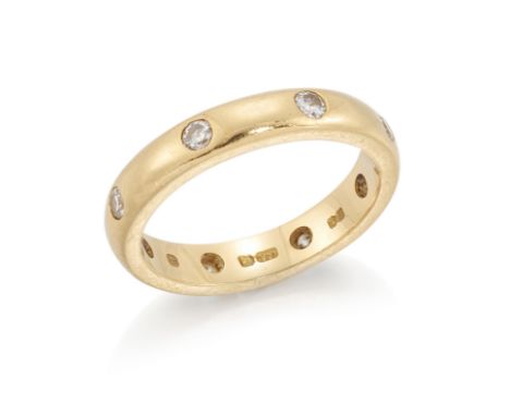 Theo Fennell. An 18ct gold diamond set band ring, the D section band flush set with brilliant cut diamonds, London hallmarks,