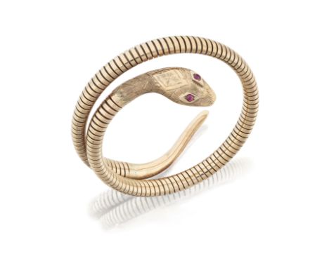 Smith & Pepper. A 9ct gold sprung serpent bangle, with cabochon ruby set eyes and coiled, sprung tubogas link body, Birmingha