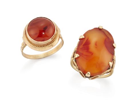 Two agate rings, the first set with an oval cabochon carnelian, claw set to openwork hoop gallery and two row wire shank, rin