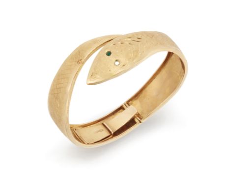 An Italian hinged snake bangle, of torque design with confronting head and tail, the eyes set with green paste (one lacking),
