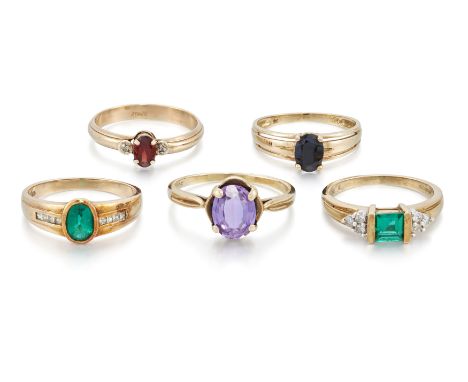 A group of five rings, comprising: a 9ct gold garnet and diamond three stone ring, Birmingham hallmarks, ring size P½;  a sap