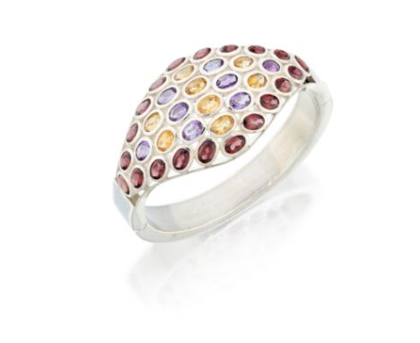 A sterling silver gem-set hinged bangle, the domed tapering upper half collet set with oval mixed cut garnets, citrine and am