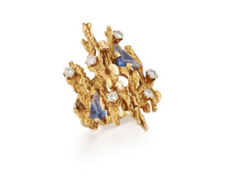 A sapphire and diamond ring, possibly George Weil, the abstract textured head claw set with scattered step cut shield shaped 