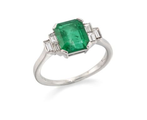 An emerald and diamond ring,&nbsp;the rectangular step cut emerald in four claw setting with stepped baguette cut diamond set