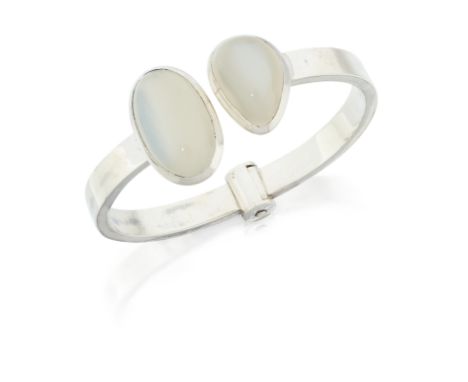 A sterling silver moonstone torque bangle,&nbsp;with collet set pear and oval cabochon moonstone terminals, flat section bang