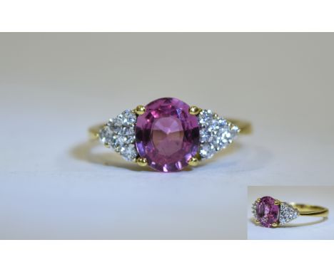 Ladies 18ct Pink Sapphire & Diamond Ring. Central oval pink sapphire set between 12 brilliant cut diamonds, Sapphire weight a