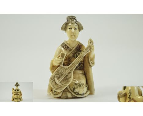 Japanese Very Finely Carved and Signed 19th Century Ivory Netsuke of a Geisha Girl Playing a Musical Instrument In a Kneeling