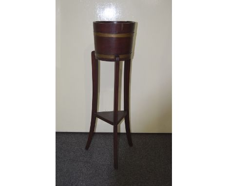 Jadiniere Stand With Tripod Base Wooden potted plant stand with metal strapped wood planter to top, triangular wooden base, a