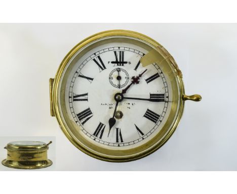 A Brass Cased Ships Clock with white porcelain dial with black numerals and secondary dial. 6.5 inches in diameter. In workin