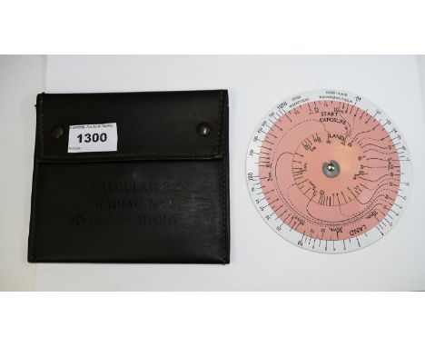 Radiac Calculator Radiac No1, rotary white plastic disc housed in field green leather pouch. Numbered 6665-99-911-0118