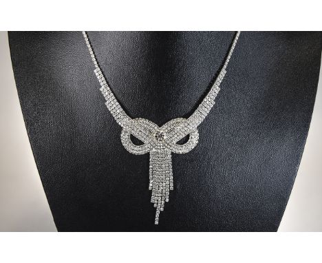 Crystal Bow Necklace and Earrings Set, the necklace, with multiple rows, reducing to a single one behind the neck, is centred