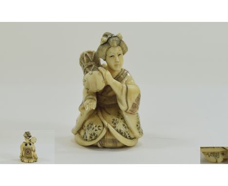 Japanese - Late 19th Century Signed and Finely Carved Netsuke. Depicting a Japanese Woman In a Kneeling Position, Holding a D