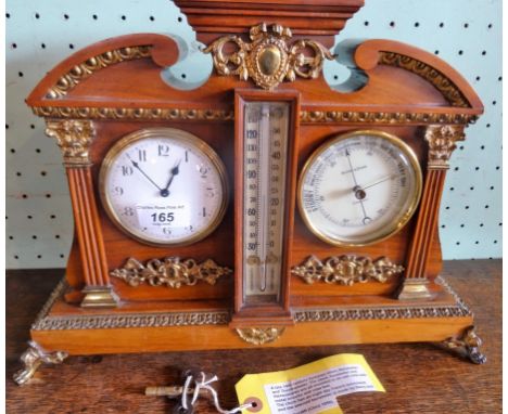 A late 19th century clock, barometer and thermometer, mounted in an oak case with ormolu mounts on four claw feet, the clock 