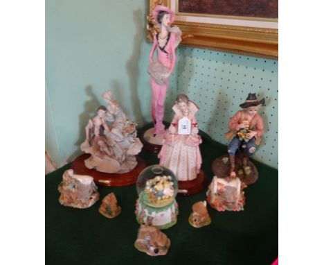 Four ornamental figurines, together with a musical snow globe, three Lilliput Lane cottages and two others.