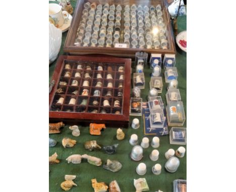 A large collection of ceramic thimbles, to include: Fenton China and Norfolk China examples, the majority contained within tw