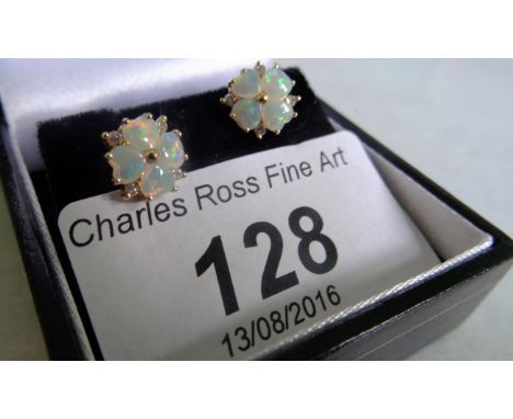 A pair of 18 carat gold opal and diamond earrings of petal form.