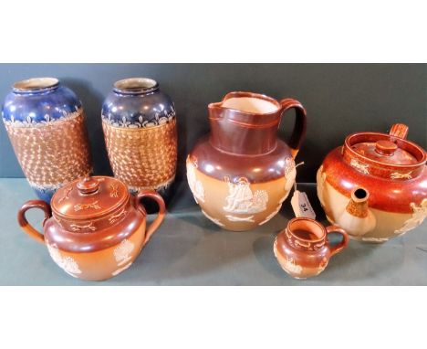 Four pieces of Royal Doulton salt-glazed tableware, to include: a harvest jug, teapot, twin handled covered bowl and small ju