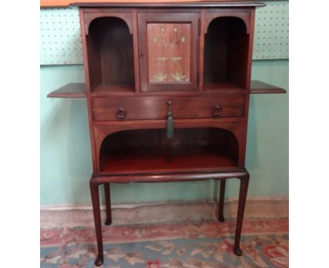 An early 20th century mahogany Arts & Crafts-style cabinet, the central cupboard door flanked by two open recesses over singl