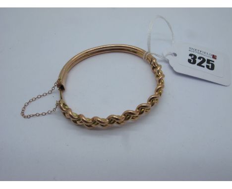 A Rose Coloured Bangle, of twisted / paited design to the front, hinged to snap clasp stamped "9c" (11grams). 