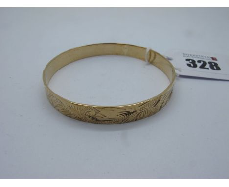 A 9ct Gold Bangle, leaf scroll engraved (internal diameter 6cm) (15grams). 
