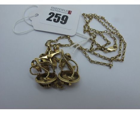 A 9ct Gold Pendant, of openwork design, as a balance scale, on a 9ct gold chain (overall weight 14grams)