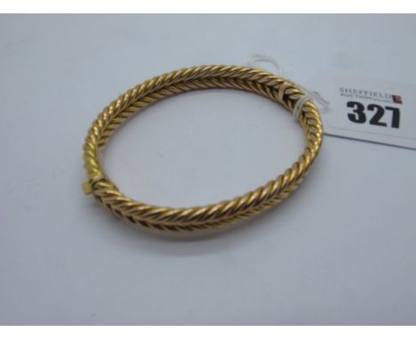 A Hinged Bangle, of two row twisted design, hinged to snap clasp stamped "9ct" (lacking safety chain) (overall weight 17grams