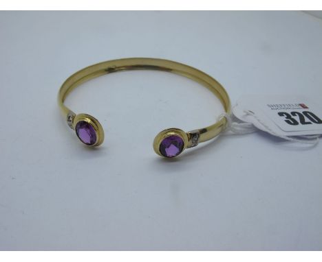 A Modern Bangle, with collet set highlights, stamped "18ct" (13grams). 