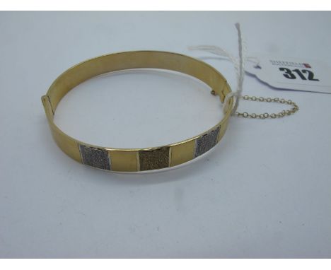 A Modern 9ct Gold Hinged Bangle, of textured two colour design to the front (15grams). 